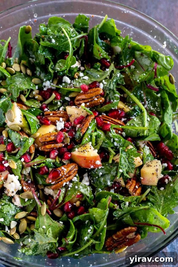 A beautiful Fresh Fall Salad with Apples and Pecans, featuring power greens, pomegranate seeds, and goat cheese.