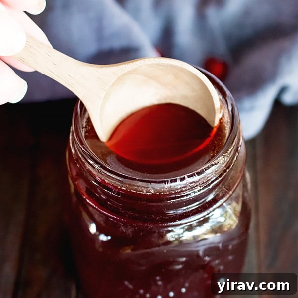 A jar of rich Homemade Pomegranate Molasses, made from scratch with real pomegranate juice.