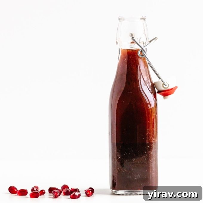 A bowl of vibrant Pomegranate Salad Dressing, a delicious sweet and tangy vinaigrette.