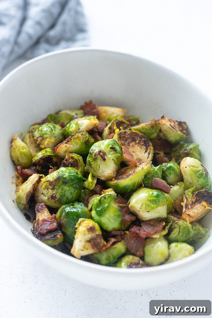 Brussels sprouts with bacon in a white serving bowl, ready to eat