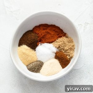 A bowl of BBQ chicken rub before all the spices are fully blended together.