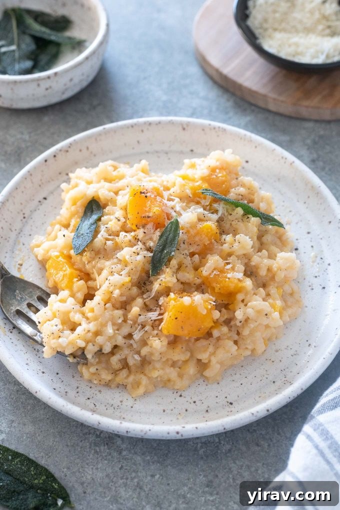 Baked butternut squash risotto on a plate with crispy sage leaves