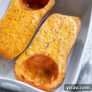Roasted whole butternut squash in a baking dish