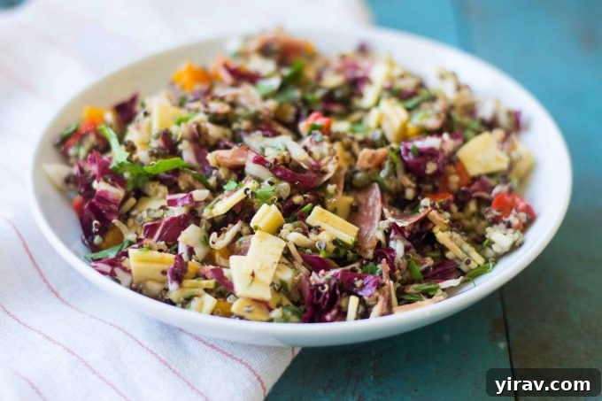 Hearty Chopped Antipasto Salad with quinoa, arugula, roasted bell peppers, salami, and gouda