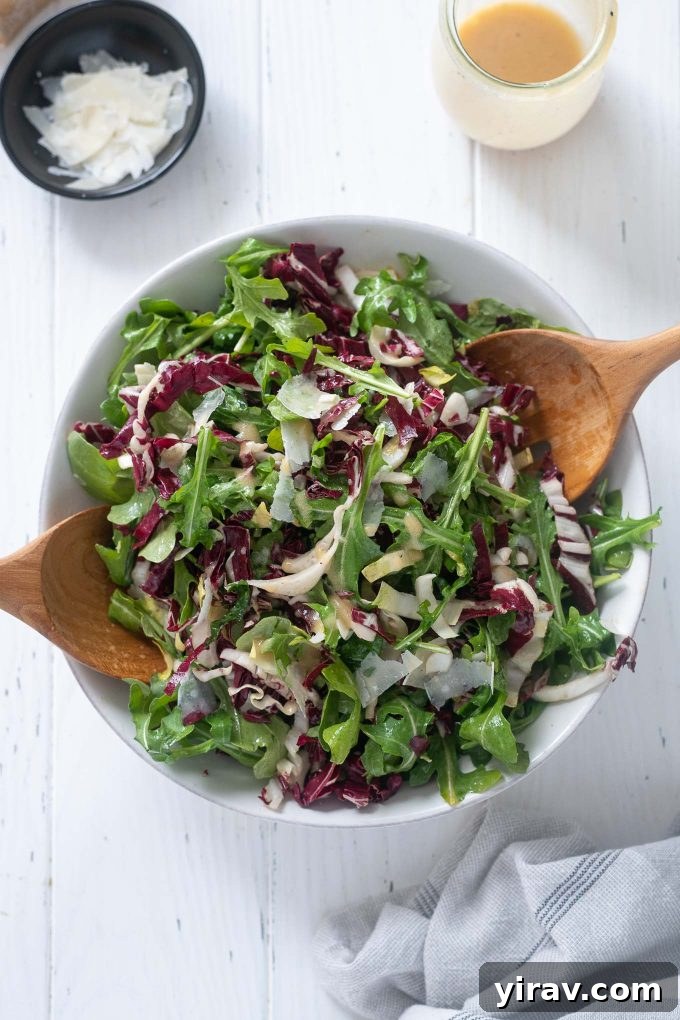 Italian Tricolore Salad in a bowl with wooden serving utensils