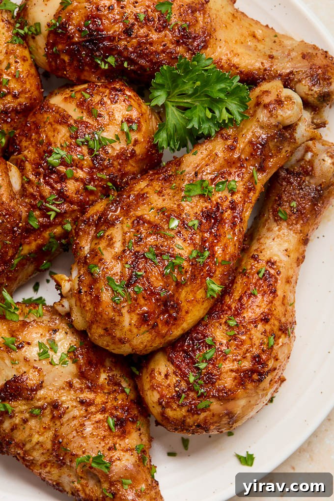 Air fryer drumsticks on a plate with parsley