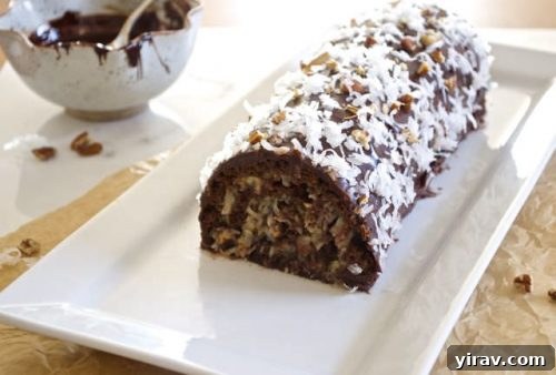 German chocolate roll cake on a white serving plate