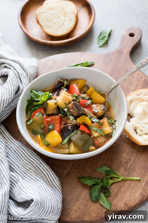 25+ Effortless Instant Pot Meals 23 bowl of instant pot ratatouille with spoon in the bowl and bread alongside