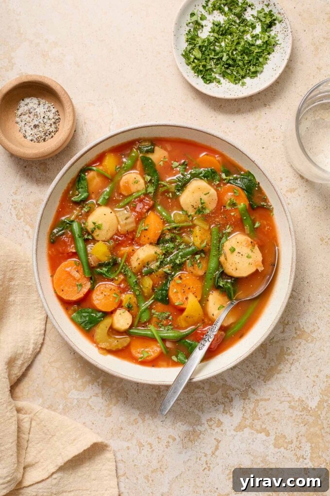 25+ Effortless Instant Pot Meals 28 Instant pot vegetable soup in a bowl with parsley and pepper.