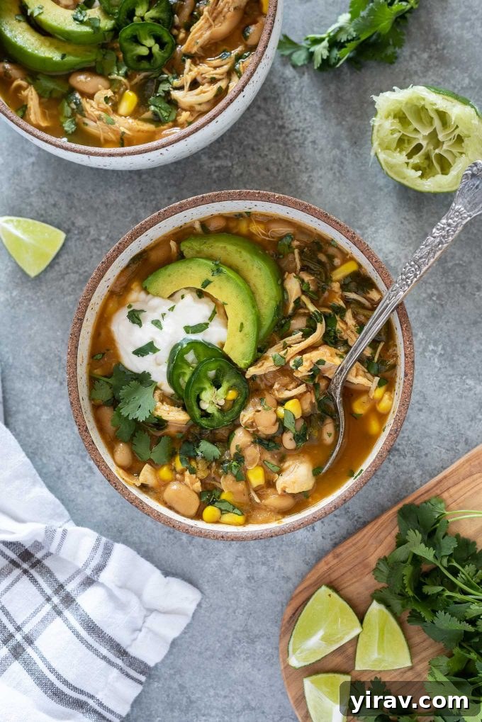 25+ Effortless Instant Pot Meals 29 Bowl of instant pot white chicken chili with spoon digging in