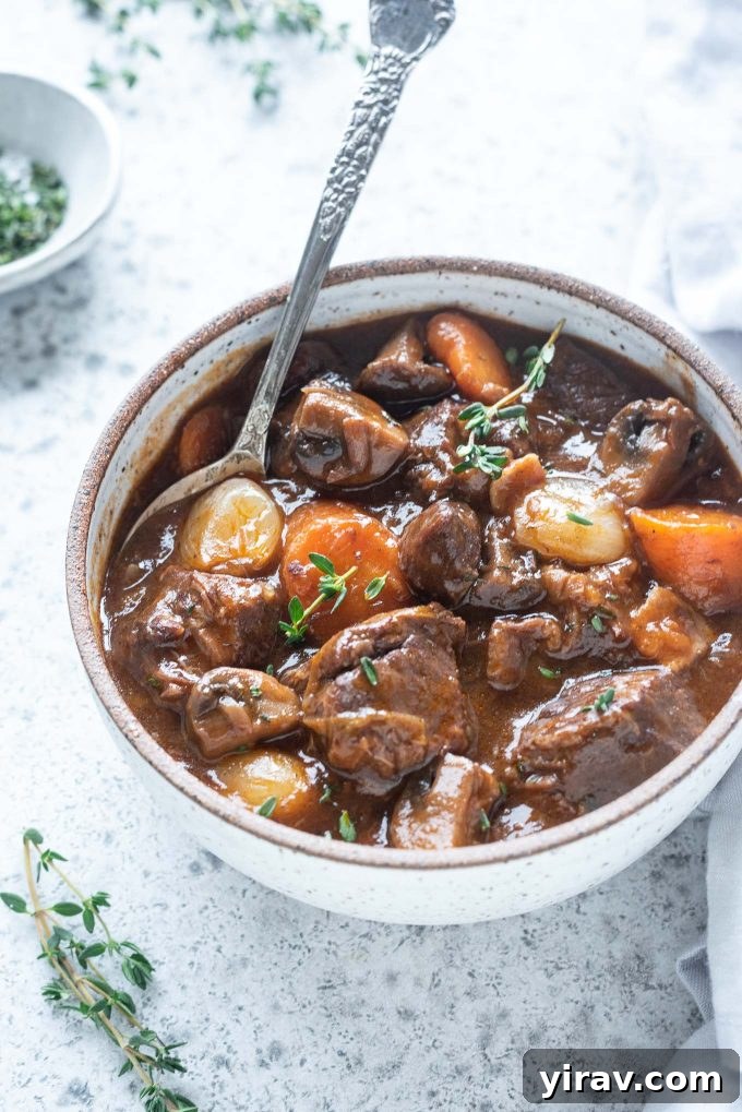 25+ Effortless Instant Pot Meals 6 Bowl of beef bourguignon with spoon digging in