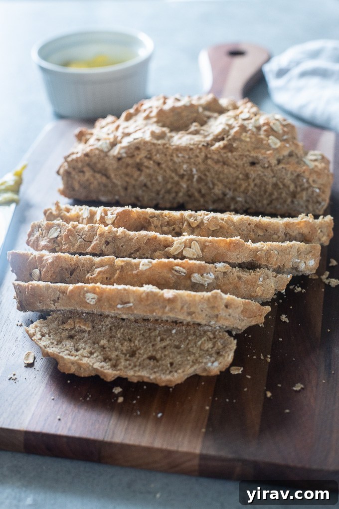 Freshly baked Irish brown soda bread sliced on a wooden cutting board