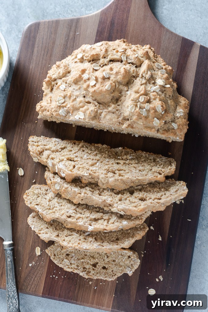 A partially sliced loaf of Irish brown bread, revealing its textured interior