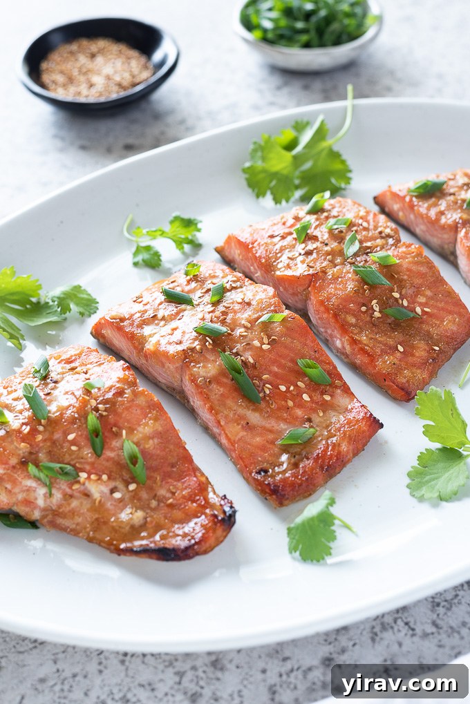 Miso salmon on a serving platter with garnishes alongside