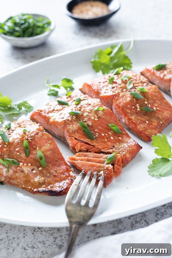 Miso marinated salmon on a platter with fork flaking fish