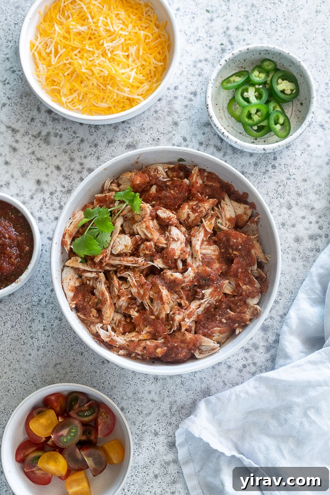 Zesty Baked Salsa Chicken 8 Shredded salsa chicken in a bowl with corn, avocado, and lime
