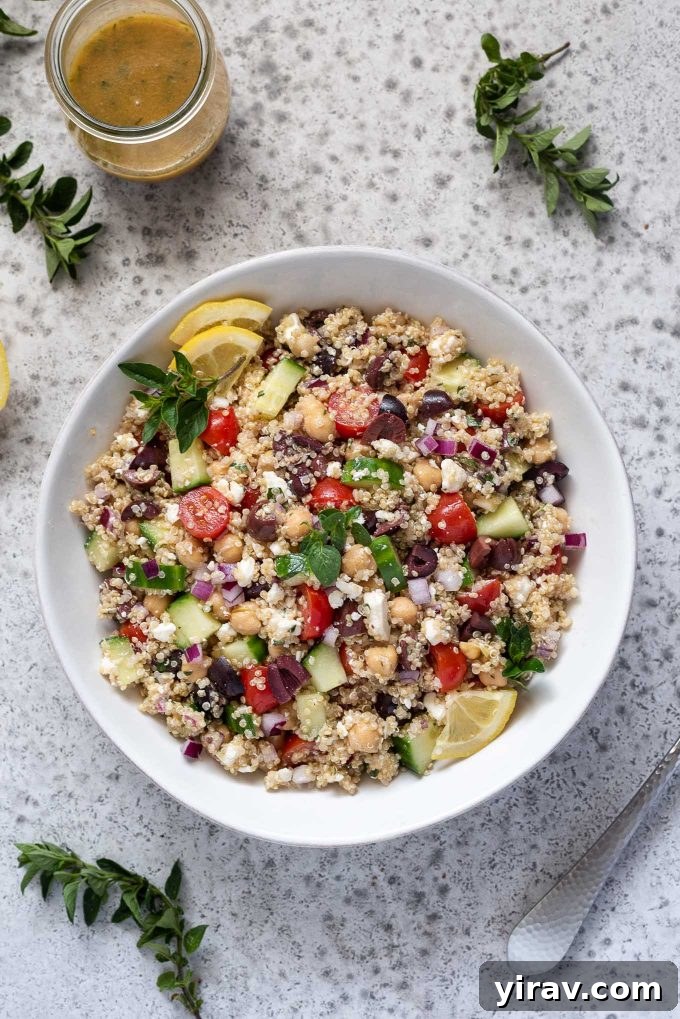 Mediterranean-inspired Greek Quinoa Salad in a white bowl, bursting with vibrant flavors and healthy ingredients.