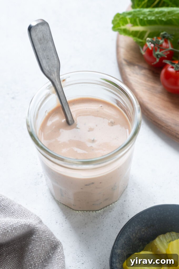 Burger sauce in a jar with a spoon buried inside