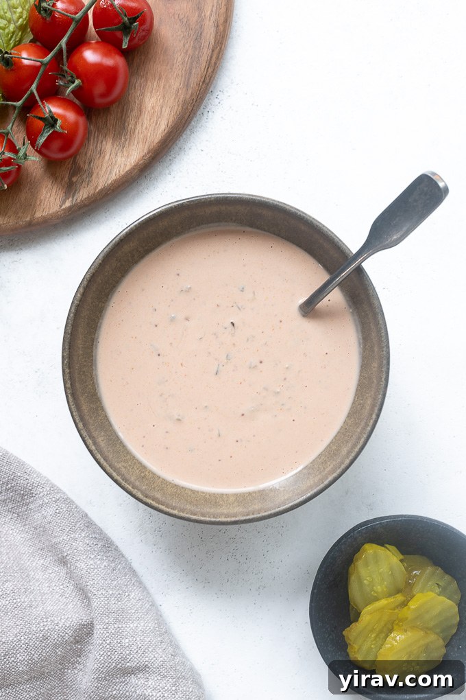 Spoon buried in bowl of burger sauce