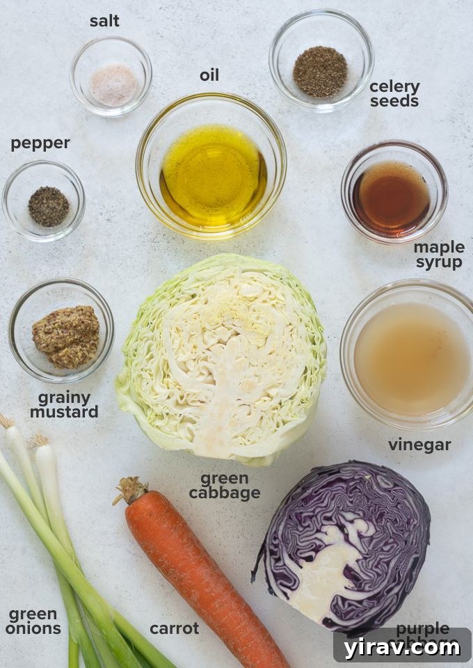 Tangy Vinegar Coleslaw 4 Assorted vinegar slaw recipe ingredients laid out on a cutting board, including cabbage, carrots, green onions, and dressing components