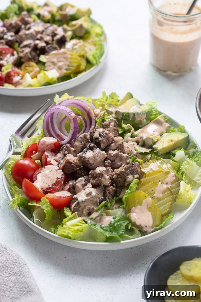 Bunless Burger Delights 6 Close-up of a delicious hamburger bowl with a vibrant mix of fresh ingredients and a generous drizzle of secret sauce, inviting a taste.