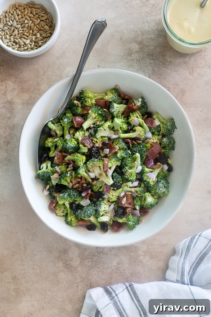 Broccoli salad with a serving spoon digging in