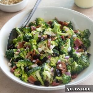 Broccoli salad with bacon in a bowl with serving spoon