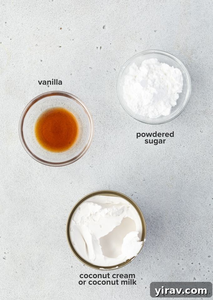Carefully arranged ingredients for coconut whipped cream, including a can of coconut cream, powdered sugar, and vanilla extract.