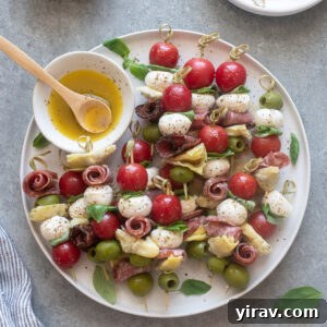 Antipasto skewers on a platter with Italian dressing.