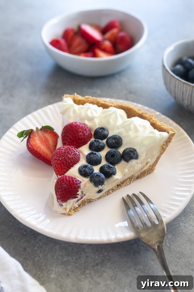 Slice of easy no bake cheesecake on a plate with berries