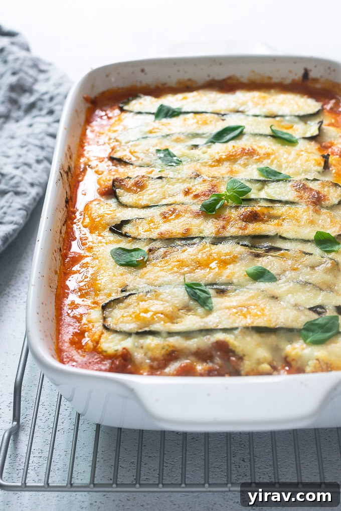 No-Noodle Zucchini Lasagna 7 Close-up of baked Keto Zucchini Lasagna in a baking dish, garnished with fresh basil.