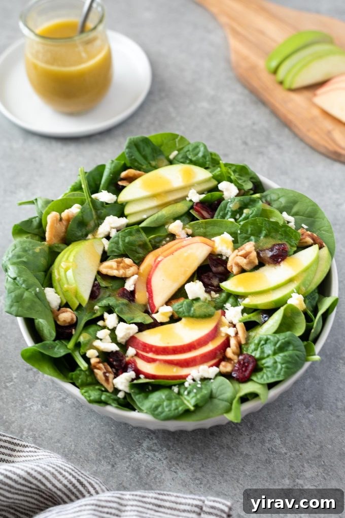 Close up of Spinach Apple Salad in white bowl
