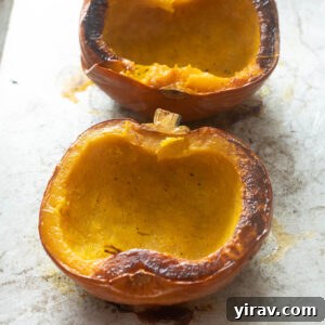Whole roasted pumpkin on a baking sheet