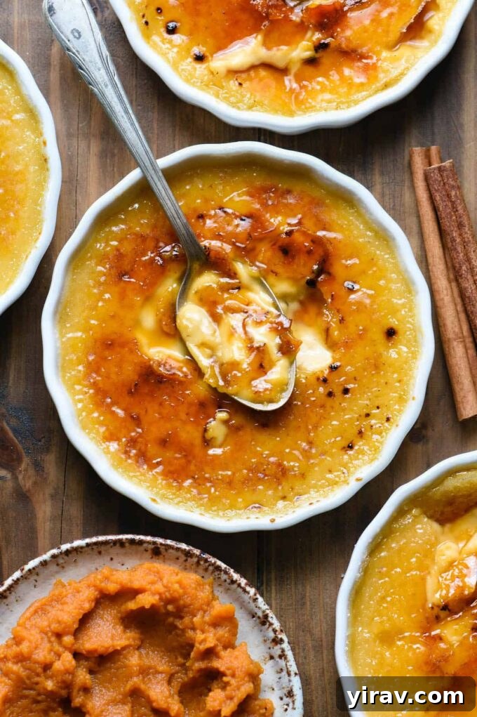 Elegant Pumpkin Creme Brulee with a spoon breaking the caramelized sugar top