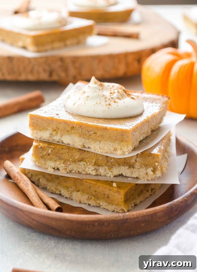 Stack of Easy Pumpkin Pie Bars topped with whipped cream