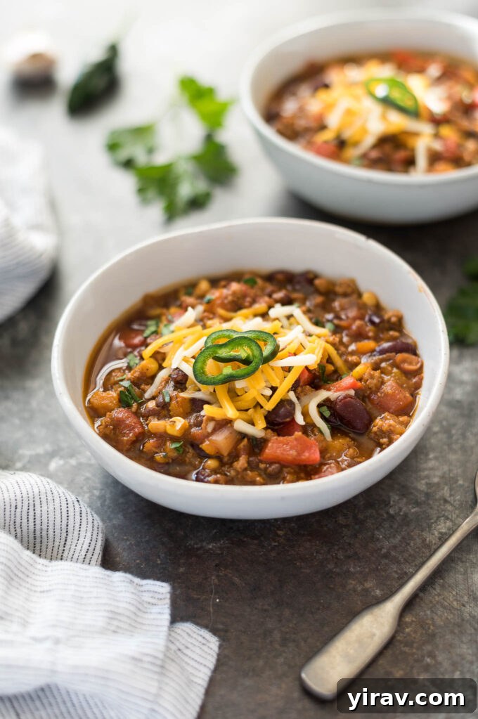 Hearty Pumpkin Chili with turkey in a bowl, garnished