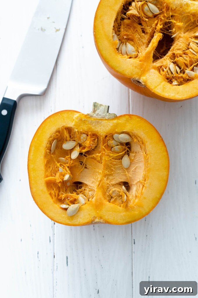 Halved pumpkin with knife nearby