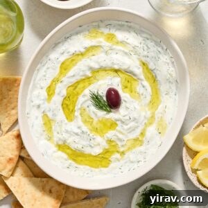 Greek tzatziki in a bowl with olive oil and dill.