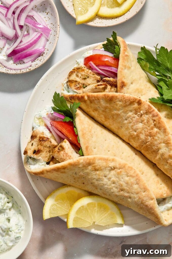 Souvlaki chicken served inside warm pita bread with tzatziki and fresh vegetables.