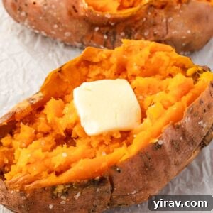 Baked sweet potato with a pat of butter melting into its fluffy interior