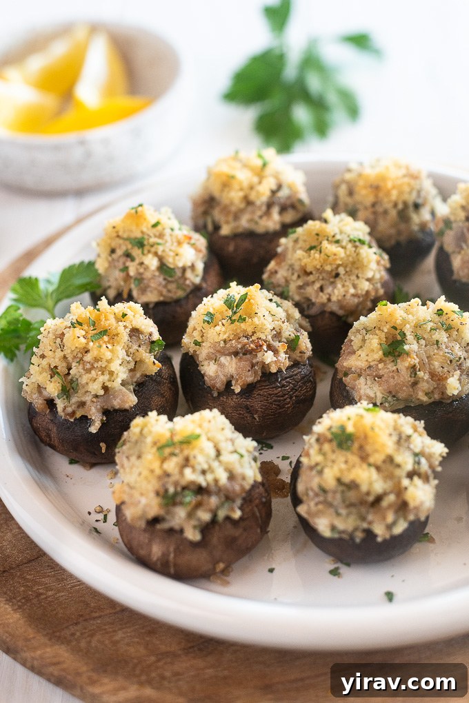 Sausage and cream cheese stuffed mushrooms on a serving plate