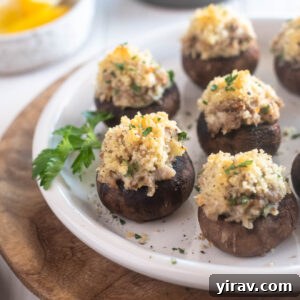 Sausage stuffed mushrooms on a plate with parsley