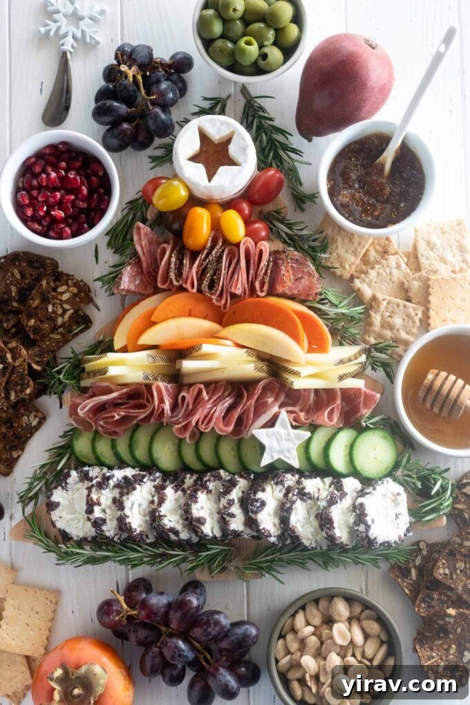 Edible Evergreen Board 2 Festive Christmas Tree Charcuterie Board topped with a star-shaped cheese, featuring an array of meats, cheeses, fruits, and vegetables arranged in a tree formation.