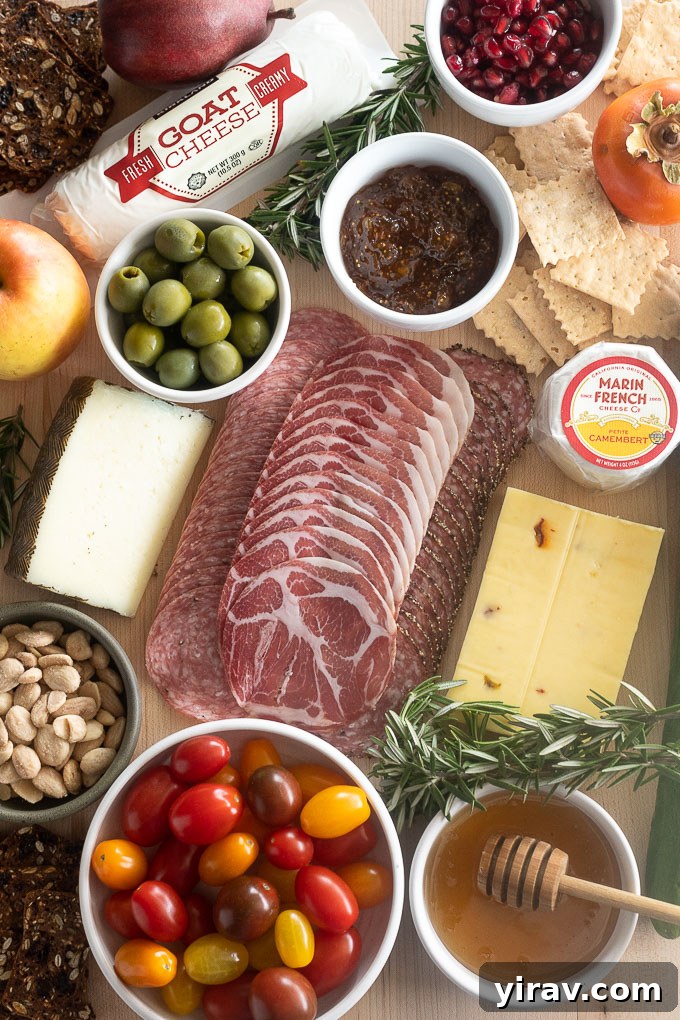 Edible Evergreen Board 4 Collection of fresh ingredients for a Christmas Tree Charcuterie Board, including various cheeses, cured meats, fruits, nuts, and crackers.