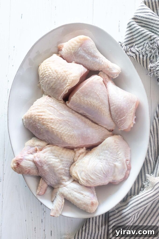 A beautifully butchered whole chicken, neatly arranged into various cuts on a serving platter, showcasing the benefits of DIY chicken processing.