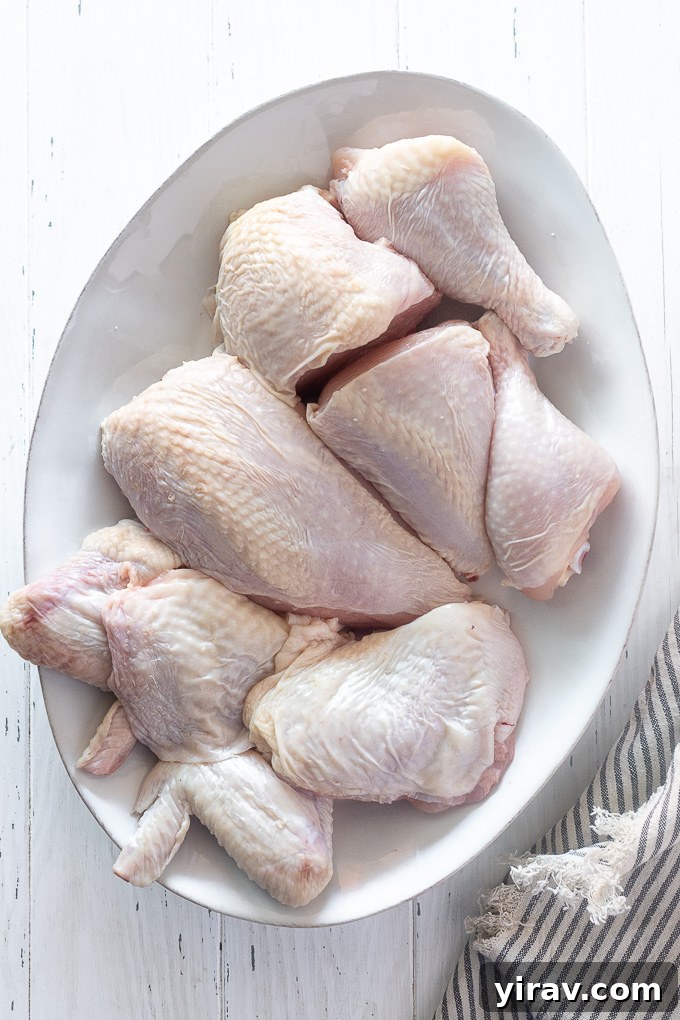 A close-up of beautifully portioned chicken pieces arranged on a platter, emphasizing the ease and elegance of home chicken butchery.