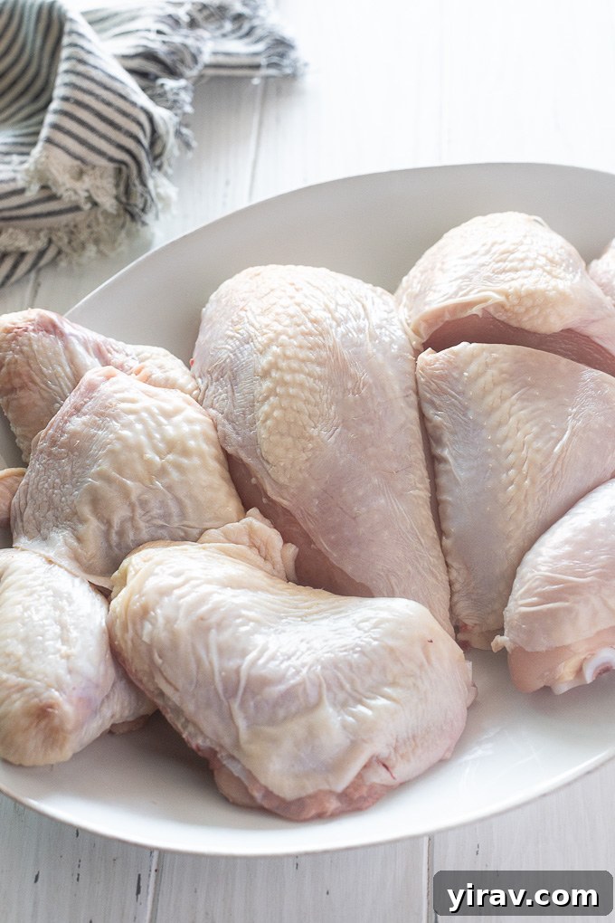 A platter laden with perfectly cut chicken pieces, ready for diverse culinary applications, highlighting the bounty of a single whole chicken.