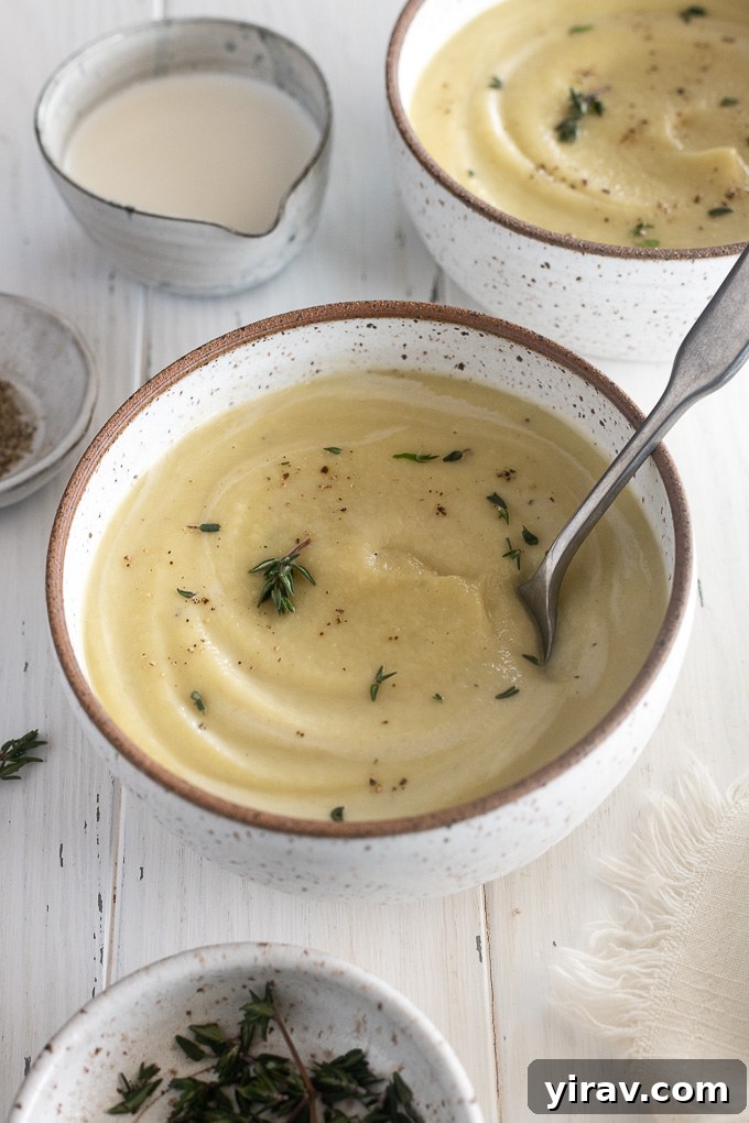 Bowl of creamy parsnip soup with a spoon buried inside