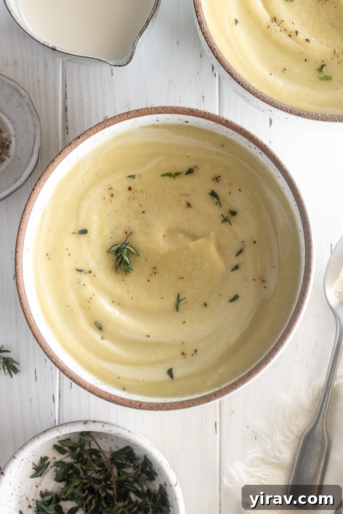 Bowl of parsnip soup with cream and thyme leaves
