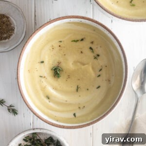 Parsnip soup in a bowl with thyme leaves